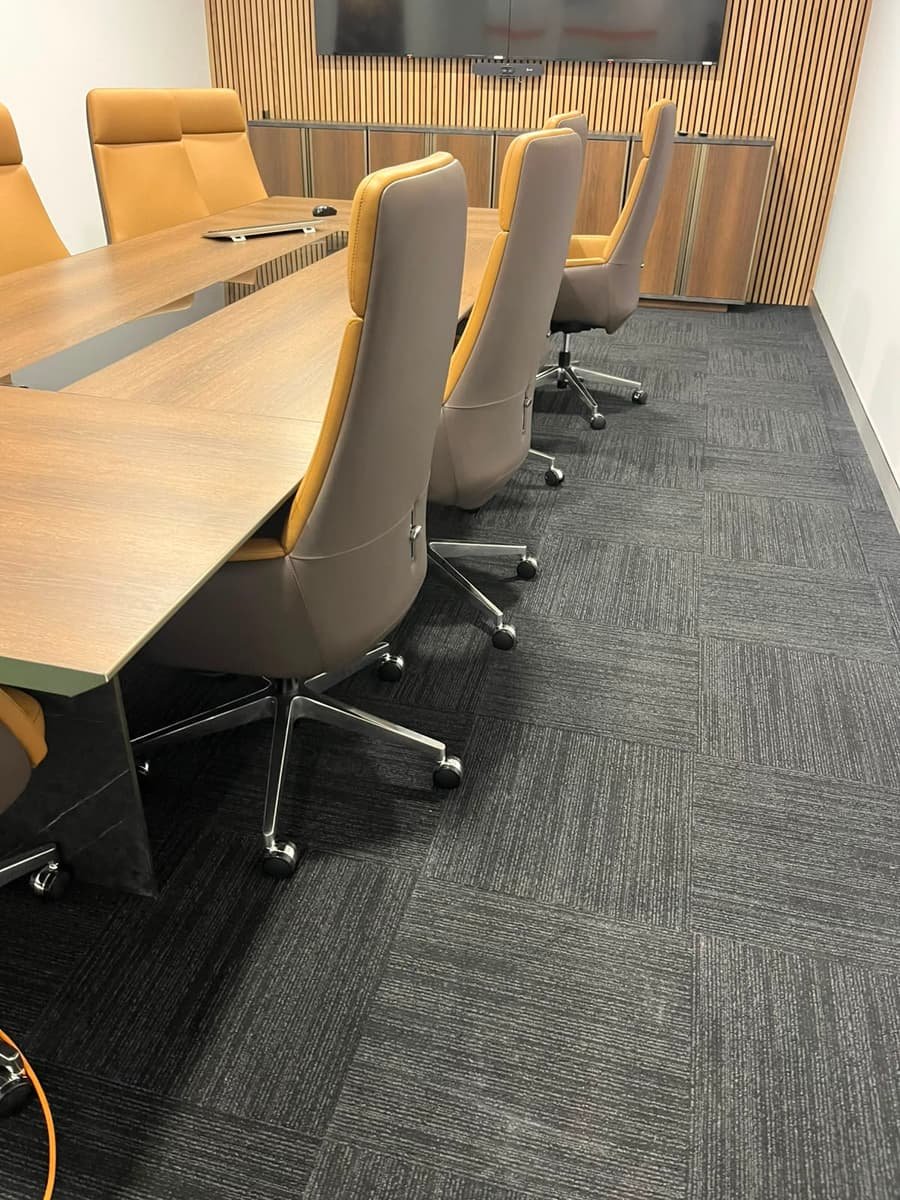 Office boardroom after cleaning — spotless table, chairs and carpet